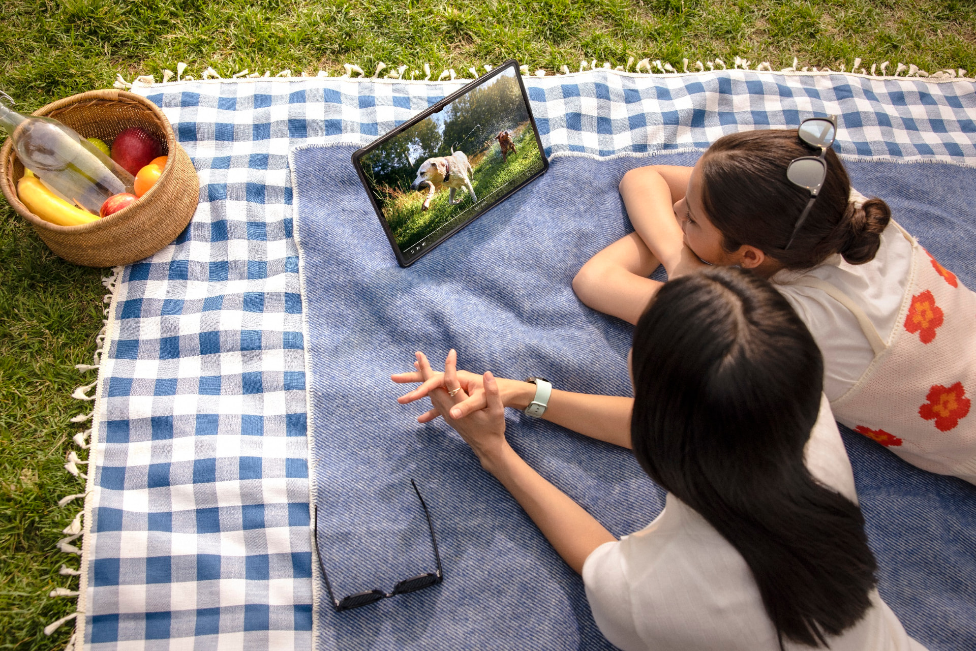 Utilisatrices regardant une tablette Samsung Galaxy Tab en extérieur